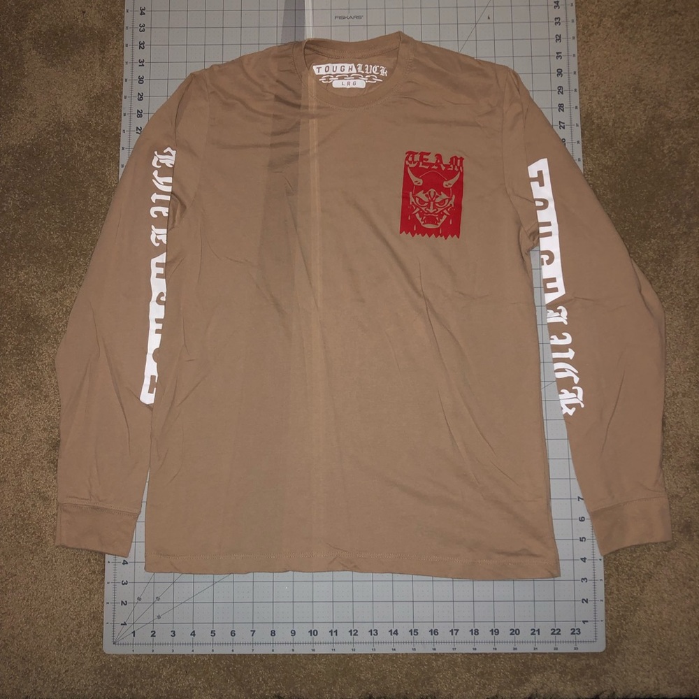Tough Luck. Size large. Tan color. Long sleeve shirt.